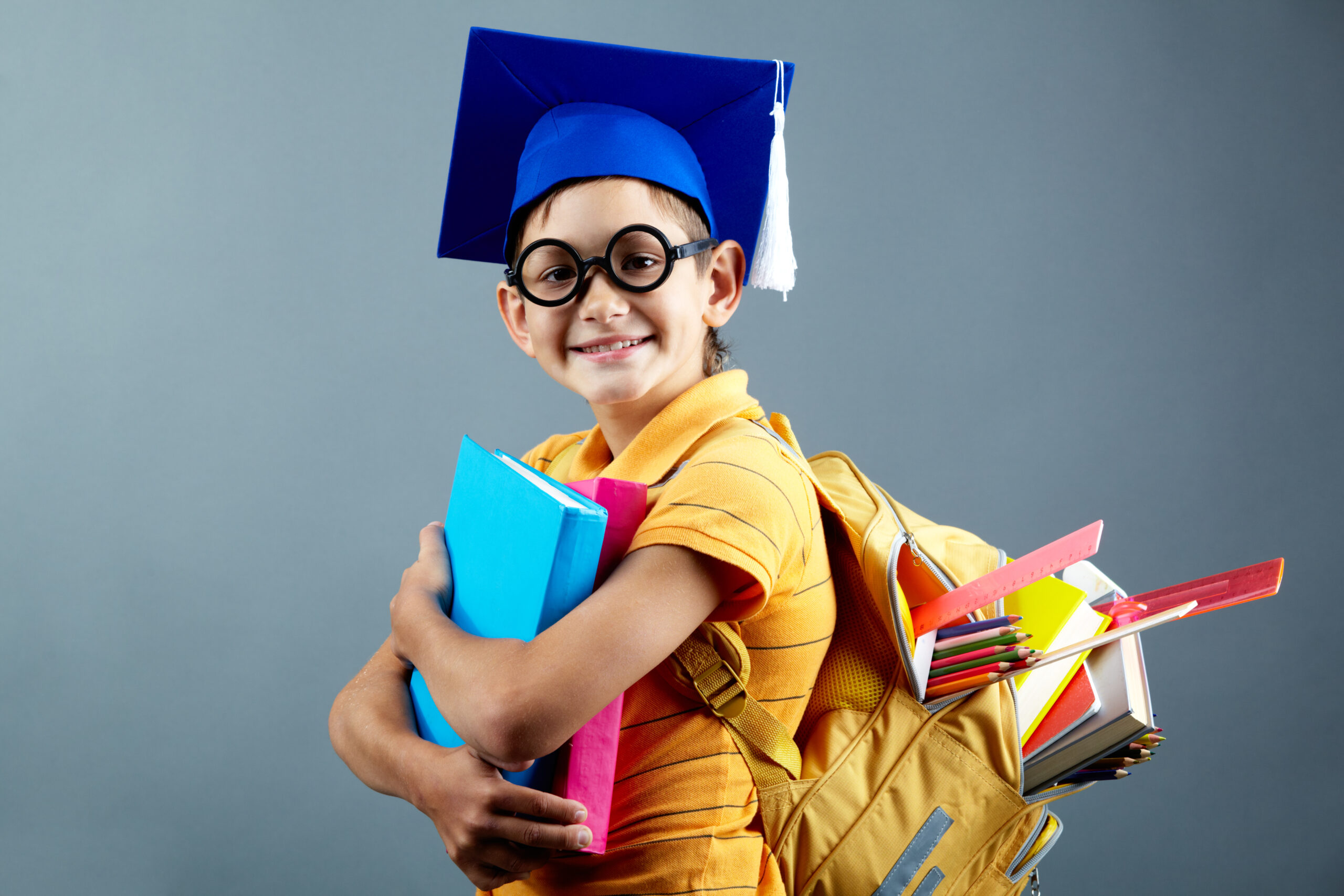 Cute schoolboy Portrait of happy schoolkid with backpack looking at camera
